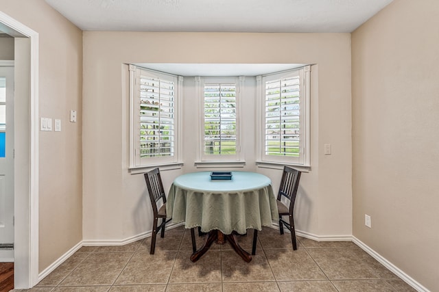 dining space with tile patterned floors and baseboards