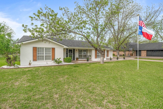 ranch-style house with a front yard, brick siding, and a shingled roof