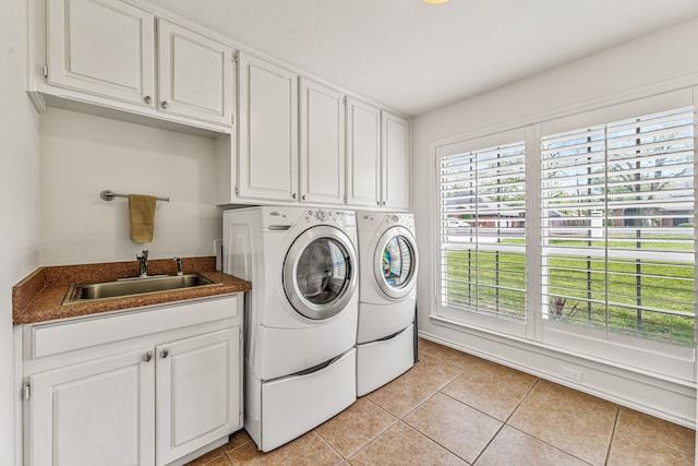 laundry room featuring washer and dryer, light tile patterned floors, a sink, and cabinet space