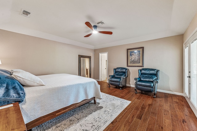 bedroom featuring a ceiling fan, baseboards, dark wood finished floors, and visible vents