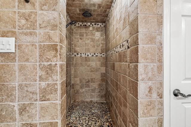 bathroom with a tile shower
