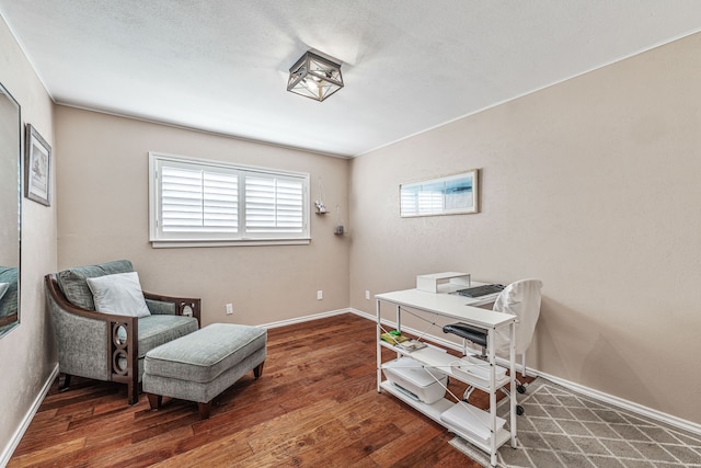 living area with baseboards and wood finished floors