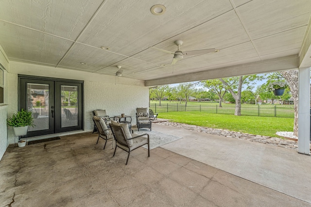 view of patio with french doors, fence, and ceiling fan
