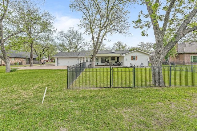 view of front facade featuring a front lawn, fence private yard, a garage, and driveway