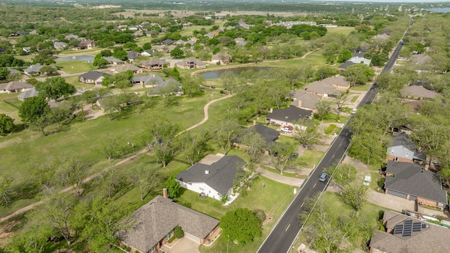 birds eye view of property with a water view and a residential view