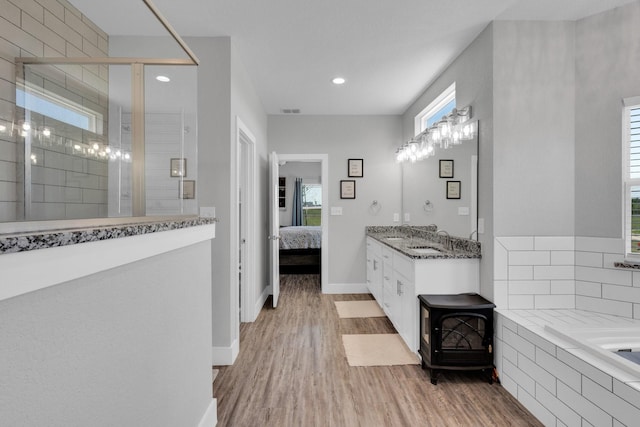 bathroom with visible vents, connected bathroom, a stall shower, and wood finished floors