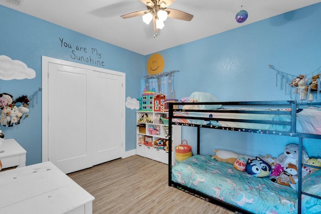 bedroom featuring wood finished floors, ceiling fan, and visible vents