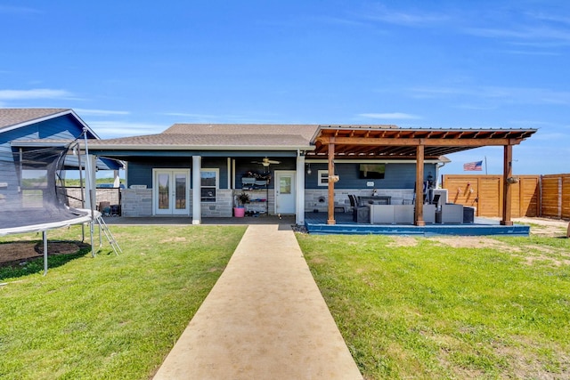 back of house with ceiling fan, a trampoline, a patio area, fence, and french doors