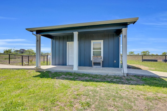 view of outbuilding featuring fence