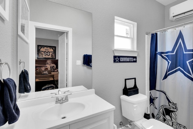 full bathroom with a shower with shower curtain, toilet, a textured wall, vanity, and a wall unit AC