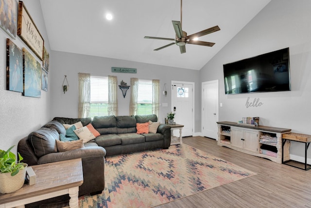 living area with high vaulted ceiling, a ceiling fan, wood finished floors, and baseboards