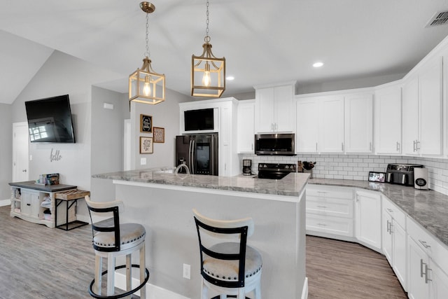 kitchen with electric range, visible vents, stainless steel microwave, backsplash, and smart refrigerator