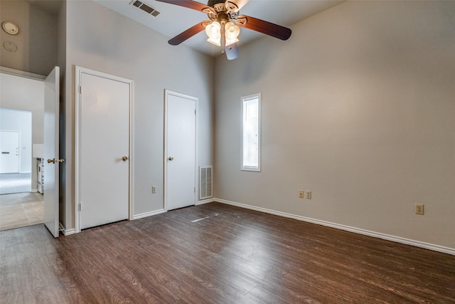 1303 N Church St, Mckinney, TX 75069 - unfurnished bedroom with visible vents, baseboards, a towering ceiling, and wood finished floors