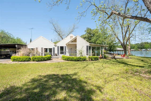 rear view of house with a carport and a lawn