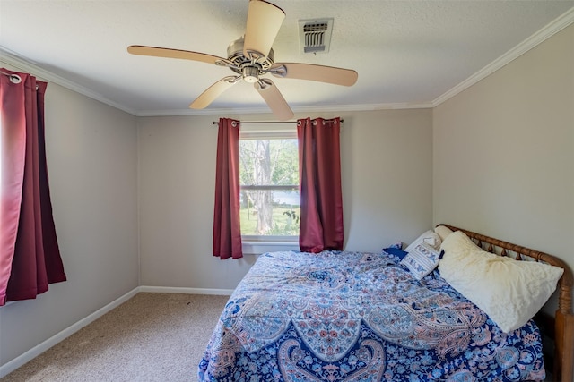 bedroom with visible vents, baseboards, ceiling fan, crown molding, and carpet flooring