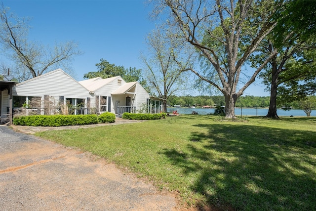 view of front of home with a water view and a front yard