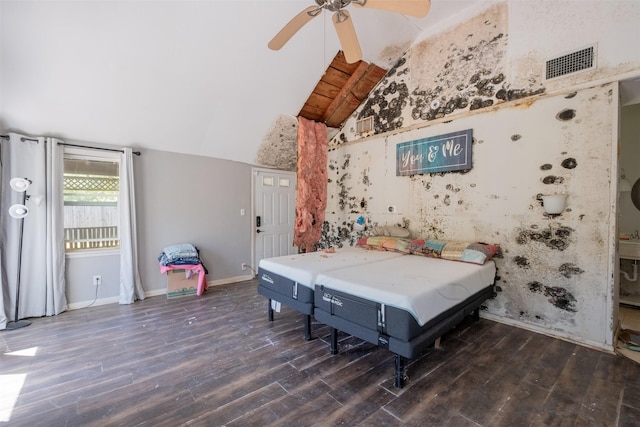 bedroom featuring visible vents, baseboards, a ceiling fan, wood finished floors, and vaulted ceiling
