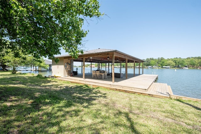dock area with a water view and a lawn