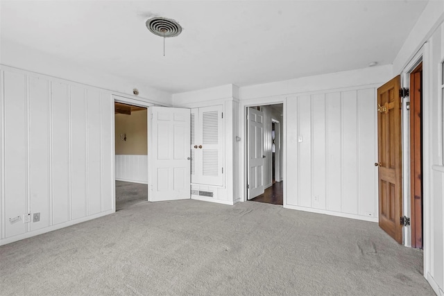 108 Hilltop Dr, Grandview, TX 76050 - unfurnished bedroom featuring a decorative wall, visible vents, and carpet flooring