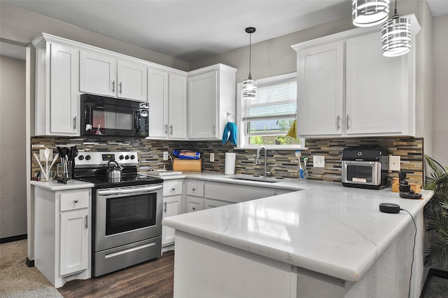 kitchen featuring a sink, a peninsula, black microwave, white cabinetry, and electric range