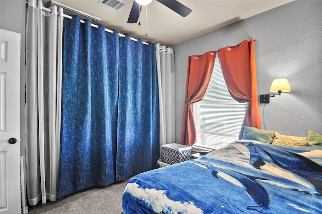 bedroom featuring visible vents, ceiling fan, and carpet flooring