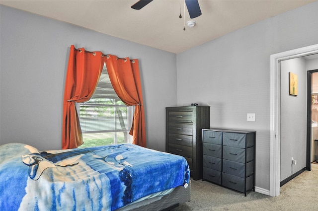 bedroom with ceiling fan, baseboards, and carpet floors