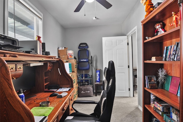 carpeted home office with a ceiling fan