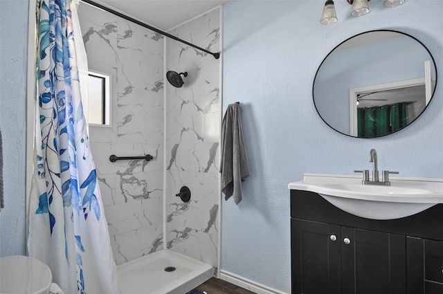 full bathroom with a shower stall and vanity