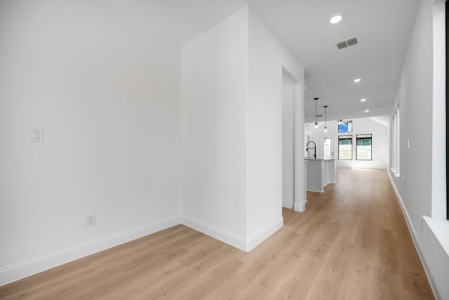 1525 Ginger Ln, Argyle, TX 76226 - hall with recessed lighting, a sink, light wood-type flooring, visible vents, and baseboards