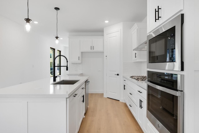 1525 Ginger Ln, Argyle, TX 76226 - kitchen featuring recessed lighting, stainless steel appliances, light countertops, white cabinets, and a sink