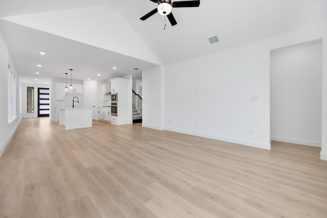 1525 Ginger Ln, Argyle, TX 76226 - unfurnished living room with stairway, ceiling fan, light wood finished floors, a sink, and visible vents