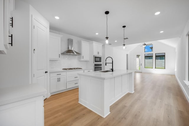 1525 Ginger Ln, Argyle, TX 76226 - kitchen with light wood finished floors, a sink, stainless steel appliances, wall chimney exhaust hood, and a ceiling fan