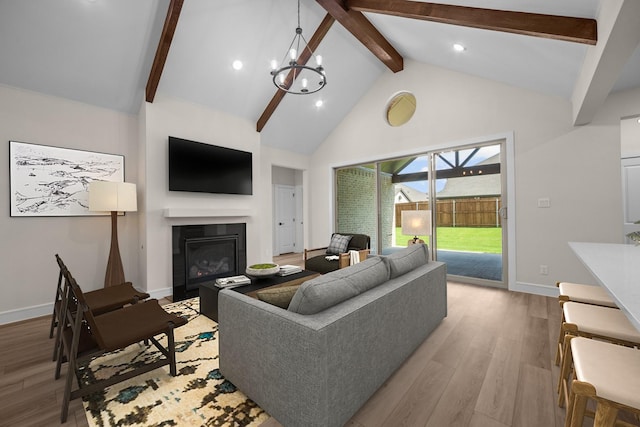 763 Emerald Hts, Lavon, TX 75166 - living room featuring beamed ceiling, baseboards, light wood finished floors, a glass covered fireplace, and high vaulted ceiling