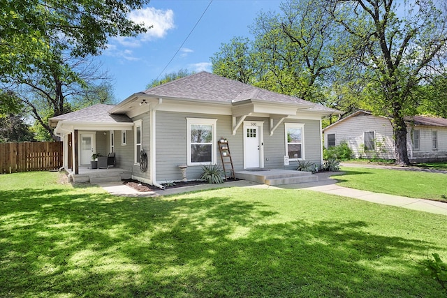 500 E Criner St, Grandview, TX 76050 - view of front of home featuring fence, a shingled roof, and a front lawn