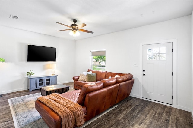500 E Criner St, Grandview, TX 76050 - living room featuring dark wood finished floors, baseboards, visible vents, and ceiling fan