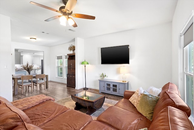 500 E Criner St, Grandview, TX 76050 - living room with baseboards, visible vents, wood finished floors, and ceiling fan