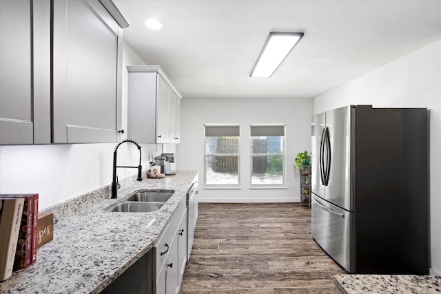 500 E Criner St, Grandview, TX 76050 - kitchen with white cabinets, a sink, appliances with stainless steel finishes, dark wood-style flooring, and light stone countertops