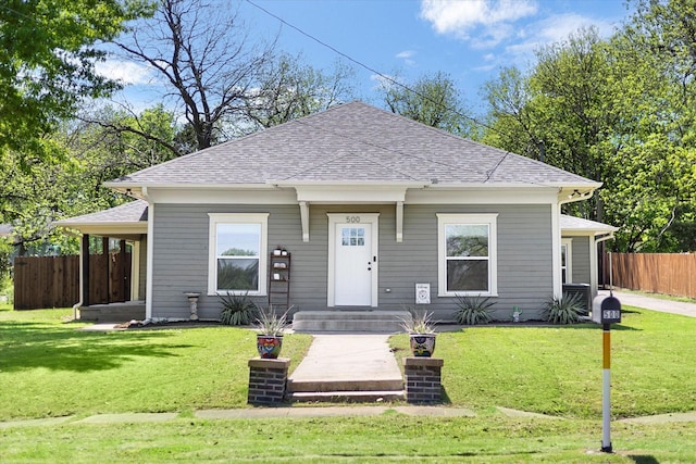 500 E Criner St, Grandview, TX 76050 - bungalow featuring fence, roof with shingles, and a front yard