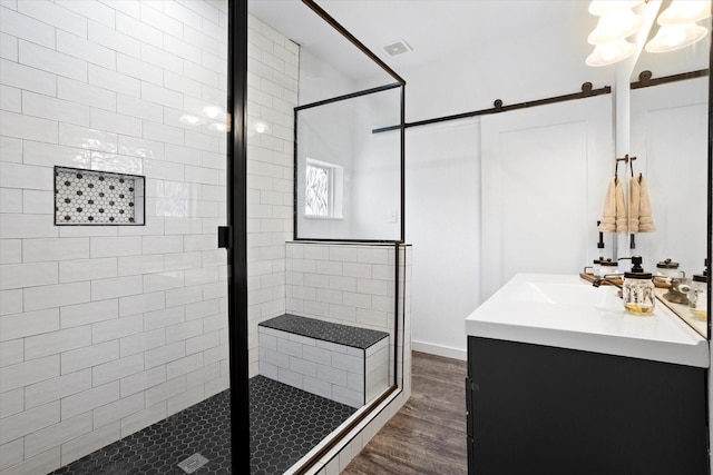 500 E Criner St, Grandview, TX 76050 - full bathroom featuring wood finished floors, a shower stall, visible vents, and vanity