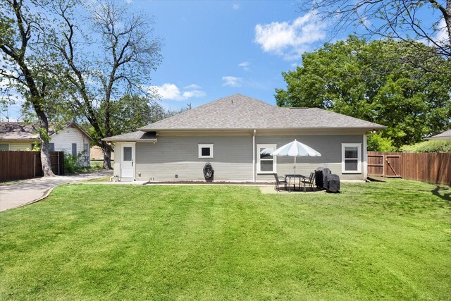 500 E Criner St, Grandview, TX 76050 - back of house featuring a yard, a shingled roof, and fence
