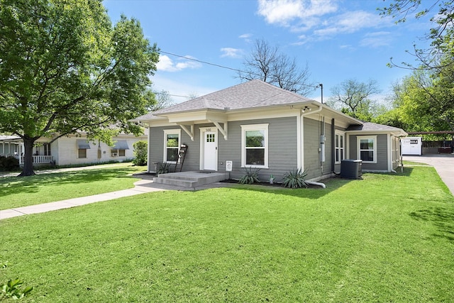 500 E Criner St, Grandview, TX 76050 - view of front of home featuring a carport, cooling unit, a front yard, and roof with shingles
