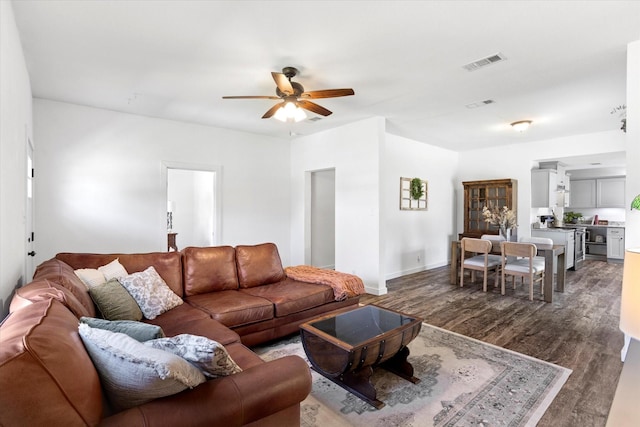 500 E Criner St, Grandview, TX 76050 - living area with baseboards, visible vents, a ceiling fan, and dark wood-style flooring