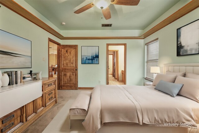 bedroom with visible vents, a ceiling fan, and light carpet