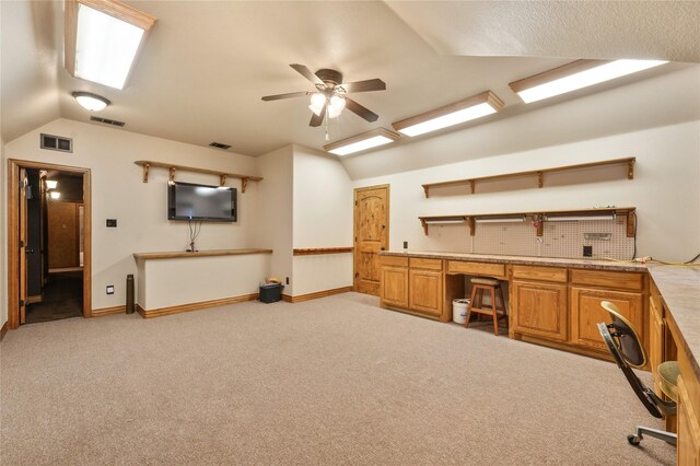 home theater room with lofted ceiling, a textured ceiling, and dark carpet
