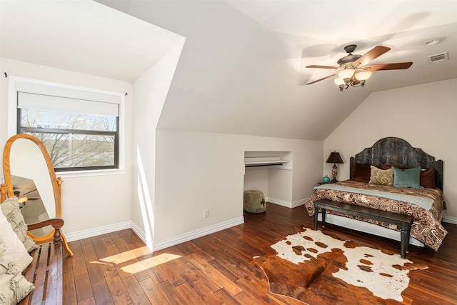 bedroom featuring baseboards, visible vents, hardwood / wood-style flooring, and vaulted ceiling