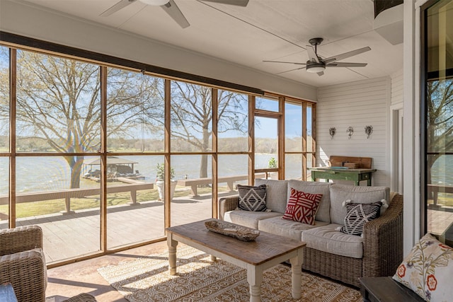 sunroom / solarium featuring a water view, outdoor lounge area, and a ceiling fan
