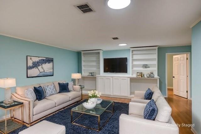 5411 Sage Dr, Bossier City, LA 71112 - living room with wood finished floors, ornamental molding, visible vents, and built in features