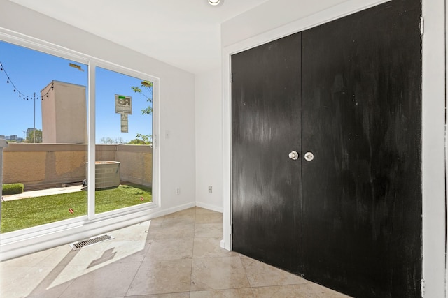 unfurnished room featuring visible vents, baseboards, and tile patterned flooring