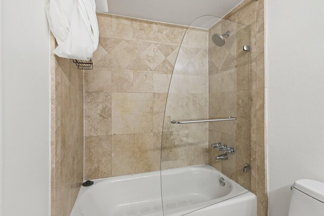 bathroom featuring shower / bathtub combination and toilet