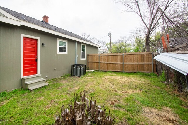 view of yard featuring fence and entry steps